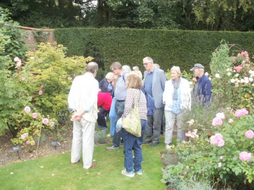A group of people standing in a garden

Description automatically generated